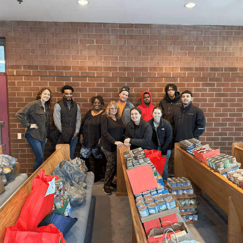 BPG Cares 2024 Holiday Food Drive - Neighborhood House Team and BPG Associates with donations